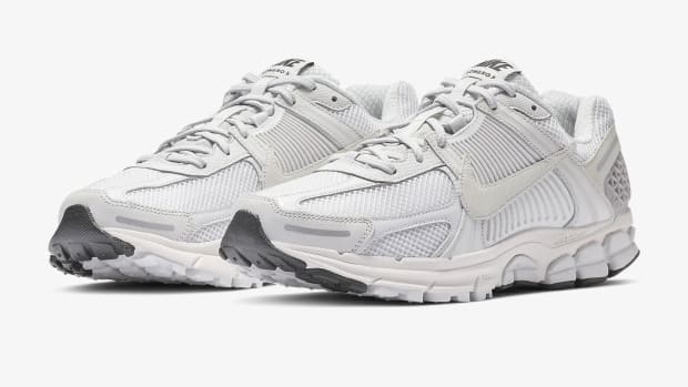 Side view of white and grey Nike sneakers.